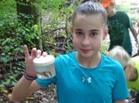 Child holding a small jar